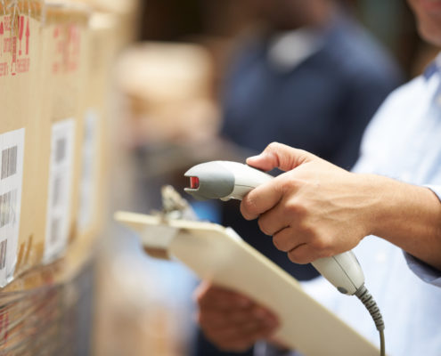 Worker Scanning Package In Warehouse